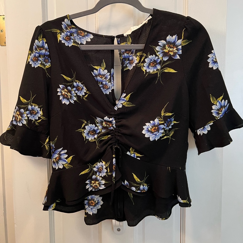 Black with blue floral slight peplum top from Astr The Label.